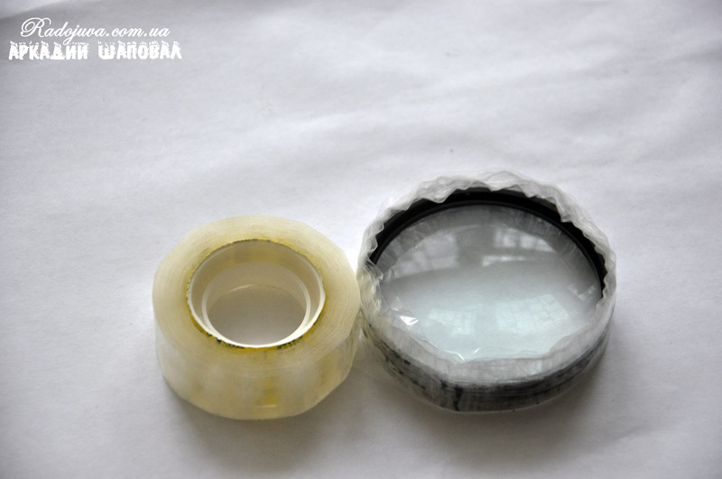 Adhesive tape wrapping on a lens