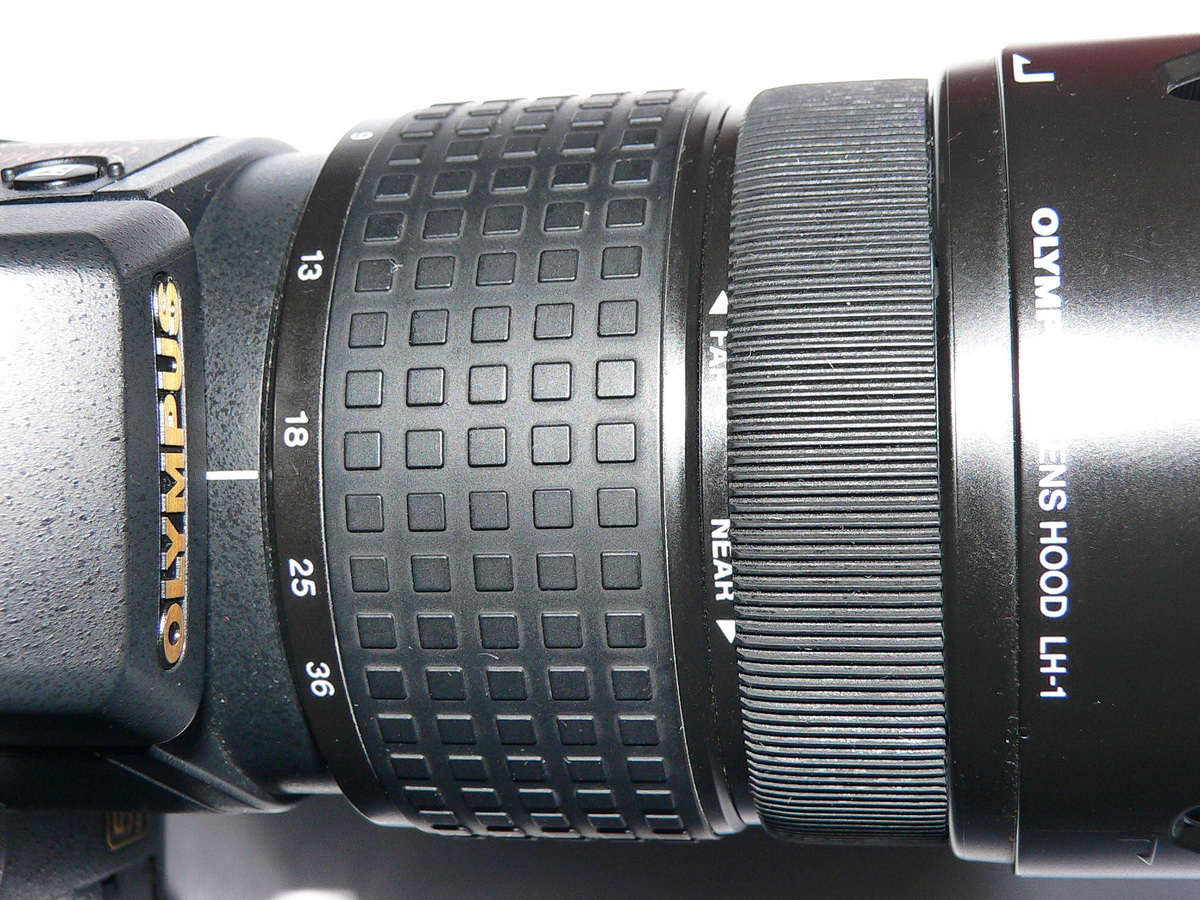 Olympus E-20: Rubber from a Sony lens is stretched over the sticky manual focus ring.